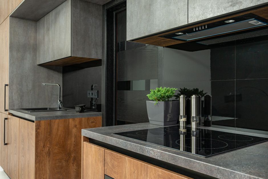 Sleek modern kitchen with wood and stone elements, emphasizing a minimalist aesthetic.